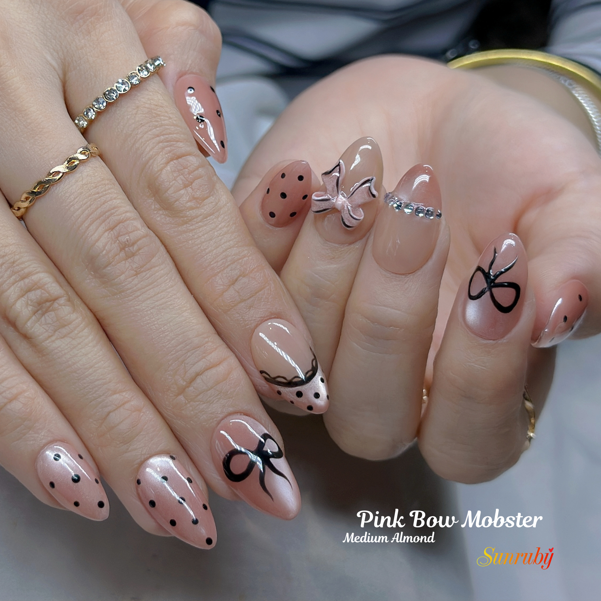 Pink Bow Mobster – Short Almond Press On Nails 🎀✨ | Nude Pink, Black Bow Art & Rhinestone Detail | Hand-Painted Gel Reusable Set, 30 Nails, 15 Sizes, Perfect Gift